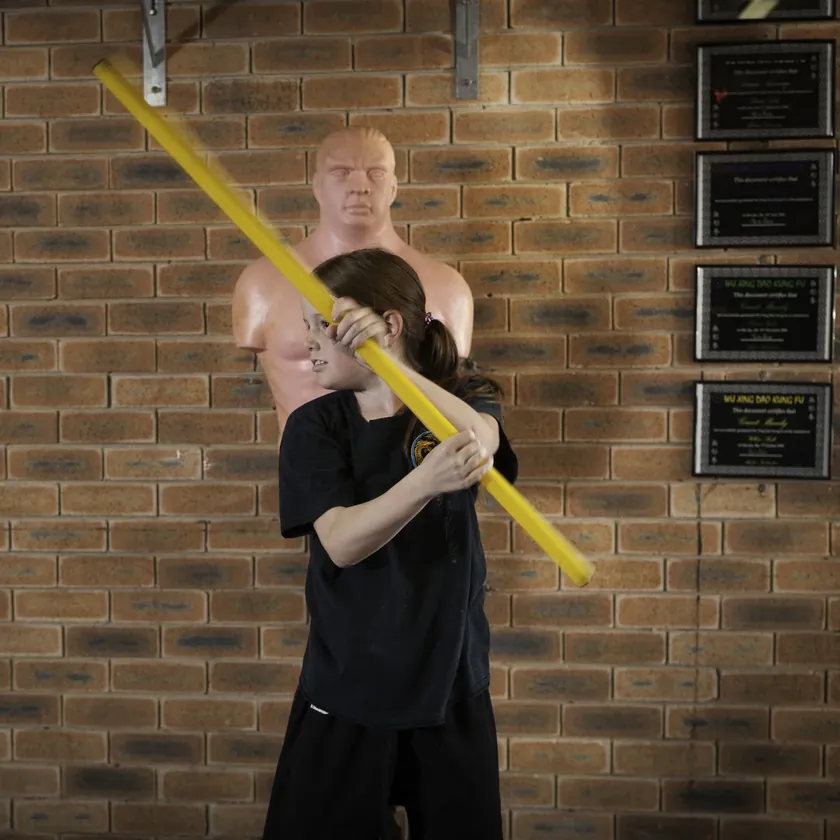 A Little Dragons student training pole skills with her instructor