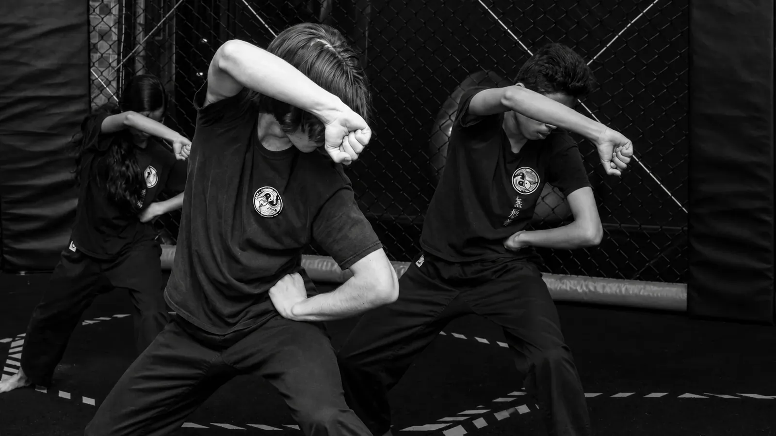 Teens training a synchronised Wu Xing Dao form together in class